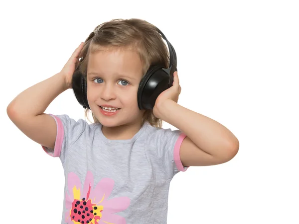 Fille écouter de la musique dans les écouteurs — Photo