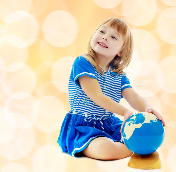 Girl turns hand globe — Stock Photo, Image