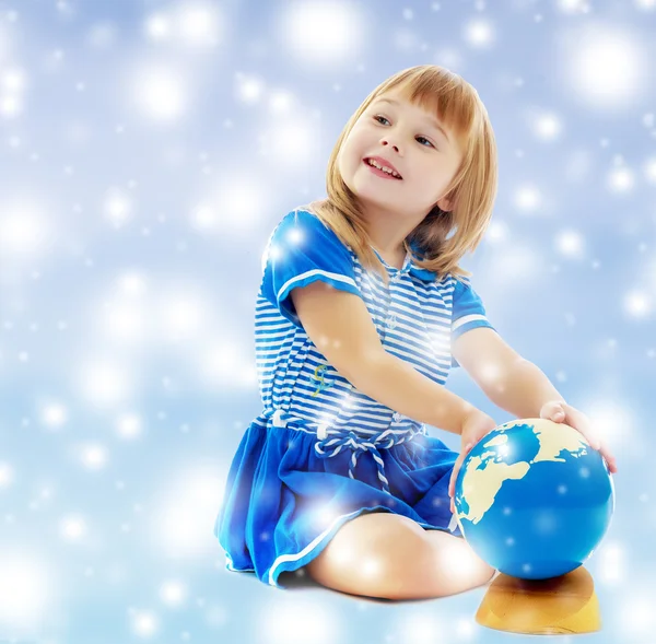 Girl turns hand globe — Stock Photo, Image