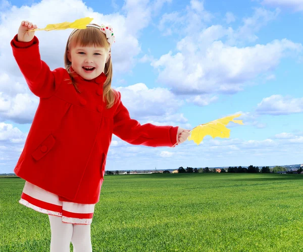 Ragazza che agita foglie d'acero — Foto Stock