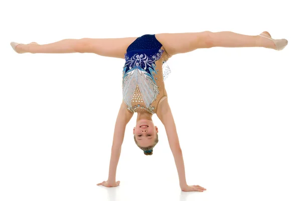 Beautiful girl gymnast performs a handstand. — Stock Photo, Image
