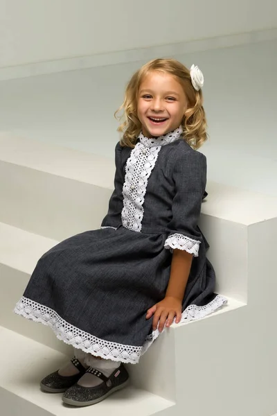 Charming little girl laughing happily in studio — Stock Photo, Image