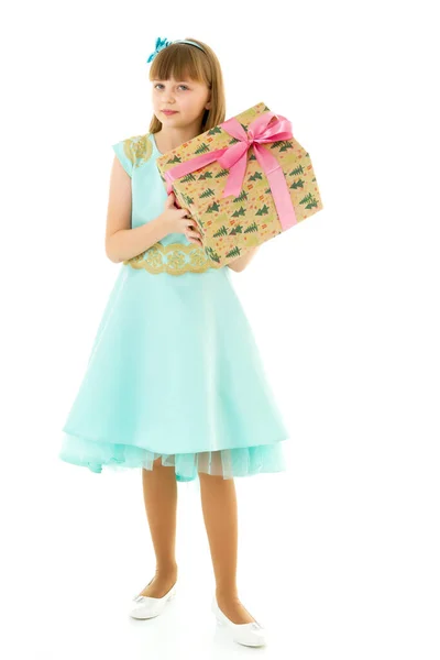 Little girl with a gift. Isolated on white background — Stock Photo, Image