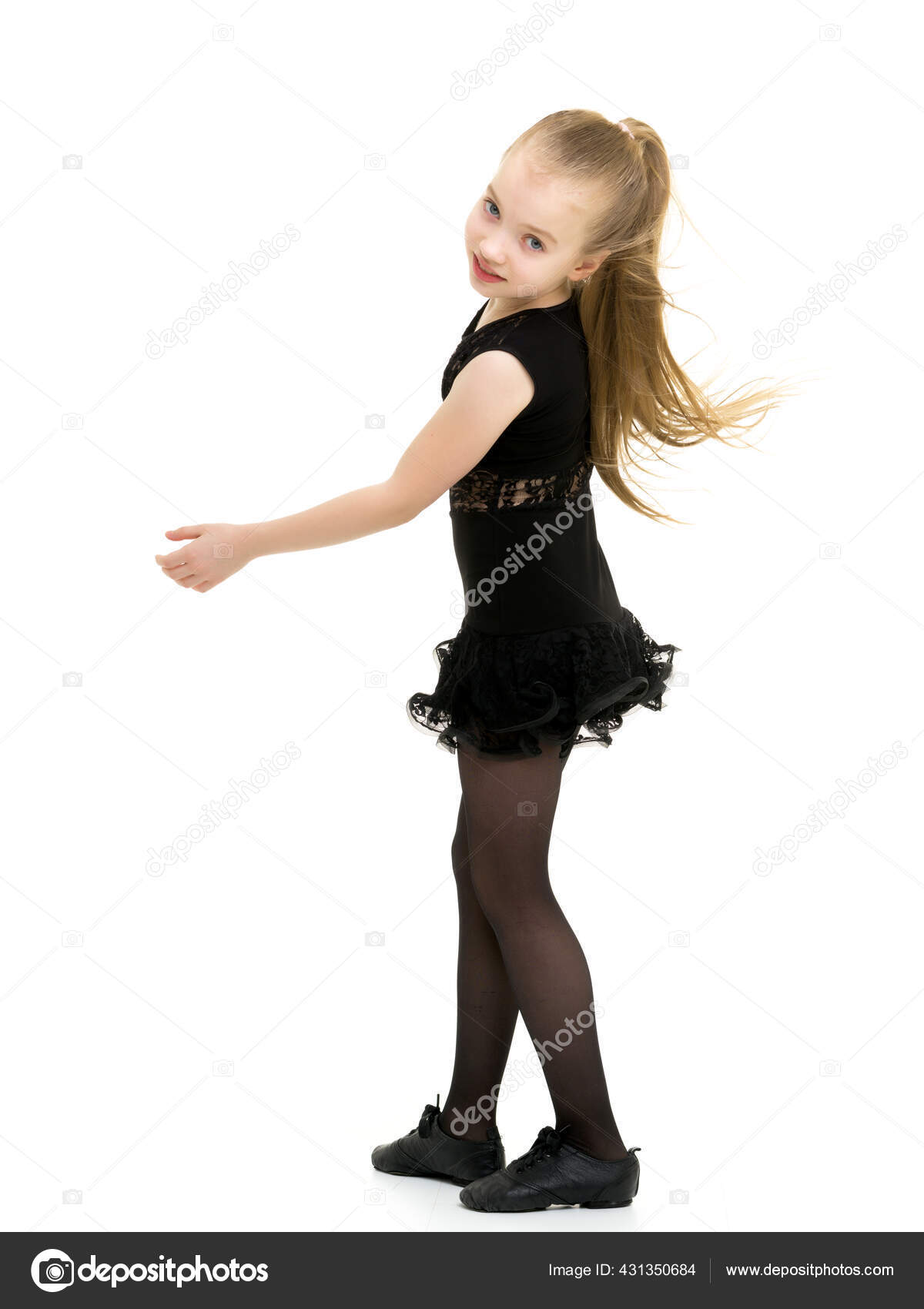 A cheerful little girl is dancing.The concept of a school of dance