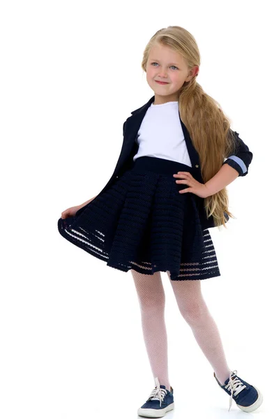 Blond meisje in schooluniform. Geïsoleerd op witte achtergrond — Stockfoto