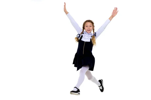 Smiling schoolgirl happily jumping high — Stock Photo, Image