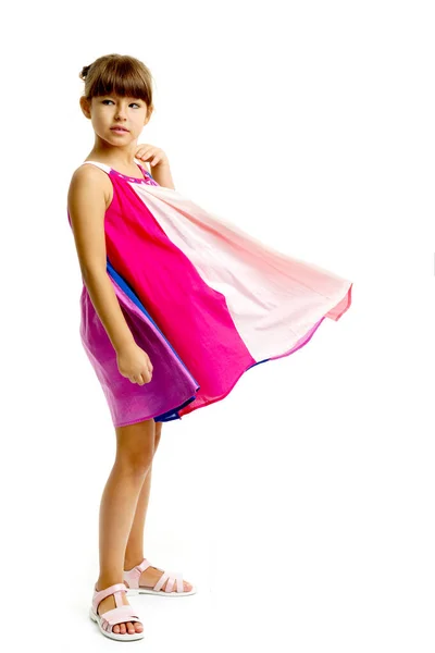 Adorable girl posing in fluttering dress — Stock Photo, Image