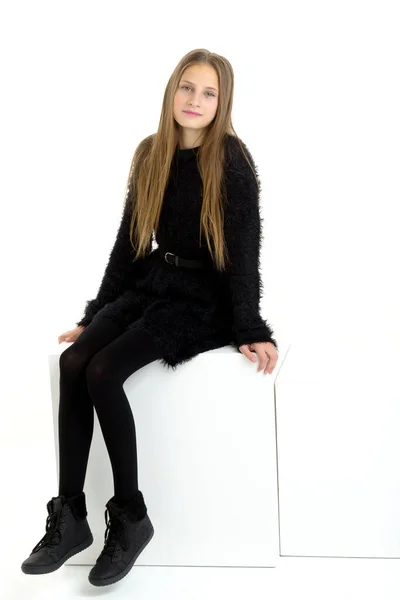 Smiling Girl In Black And White Striped Tights Sitting On A White Cube  Stock Photo, Picture and Royalty Free Image. Image 48395289.