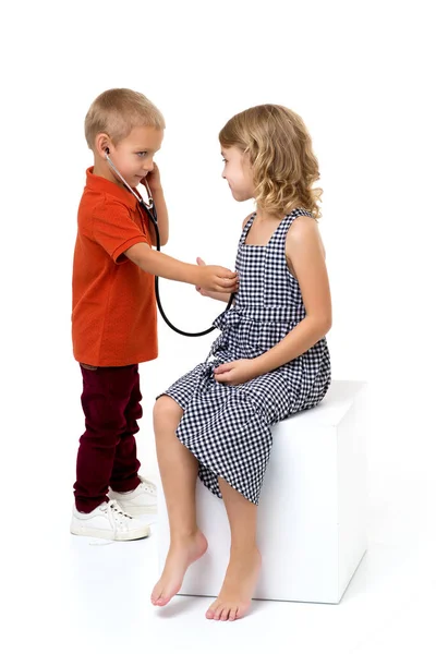 Cute children playing doctor and patient. Photo session in the studio Stock Image
