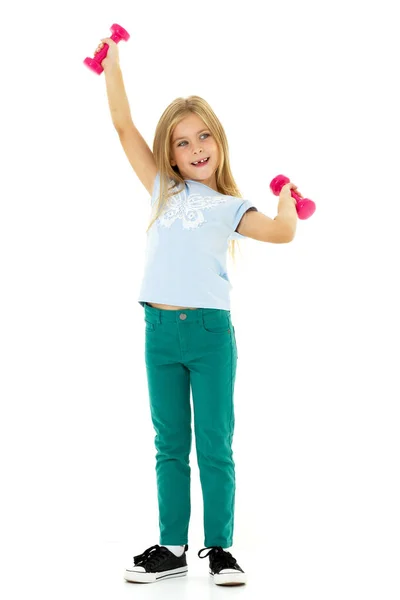 Little girl doing exercises with dumbbells.. Photo session in the studio — Stock Photo, Image