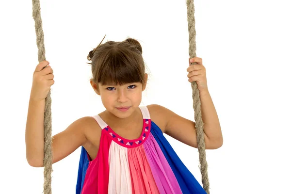 Cute girl having fun on wooden swing — Stock Photo, Image