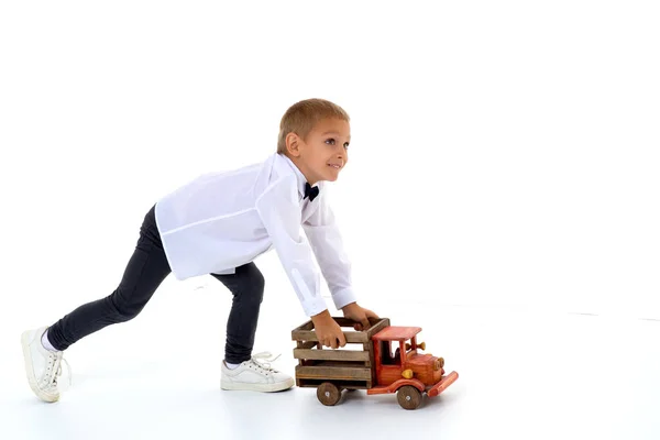 A little boy is playing with a toy car. — Stock Photo, Image