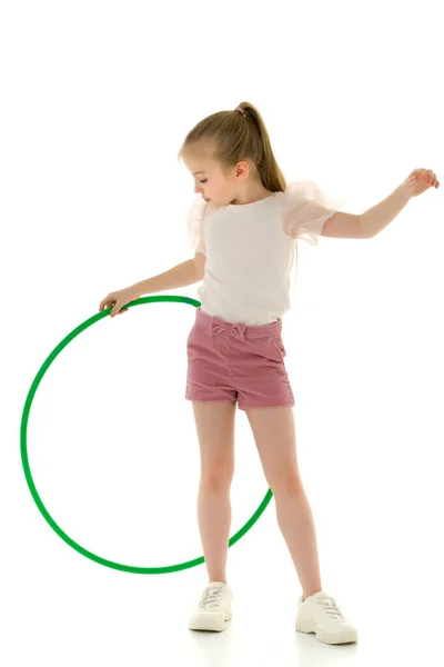 The little girl turns the hoop. — Stock Photo, Image