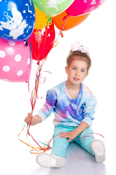 Adorable little girl with colorful balloons — Stock Photo, Image