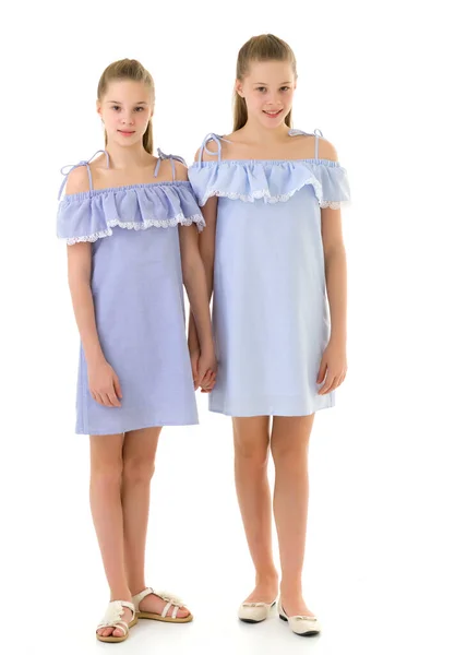 Sisters in Identical Light Dresses Standing and Holding Hands — Stock Photo, Image