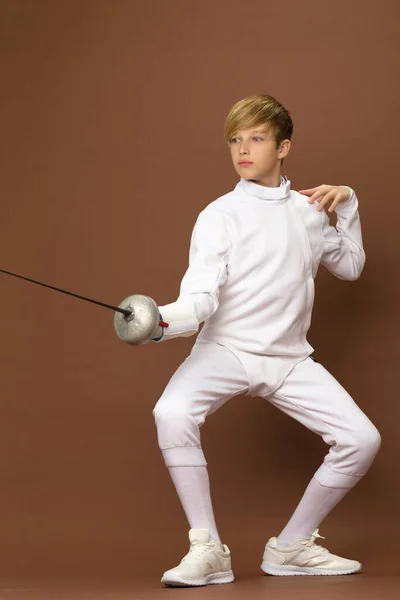 Boy fencer standing in attacking pose — Stock Photo, Image