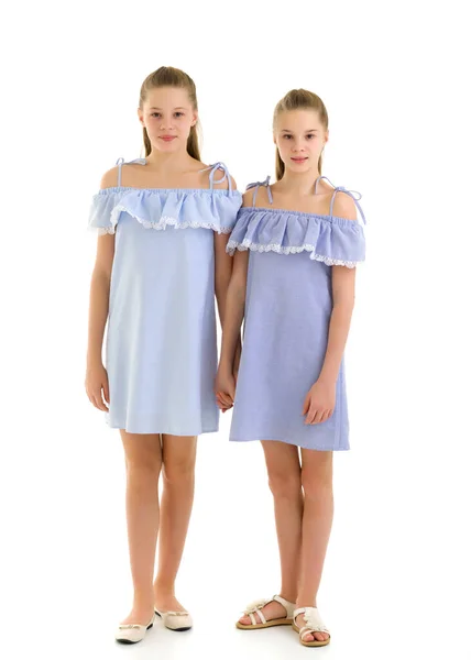 Sisters in Identical Light Dresses Standing and Holding Hands — Stock Photo, Image