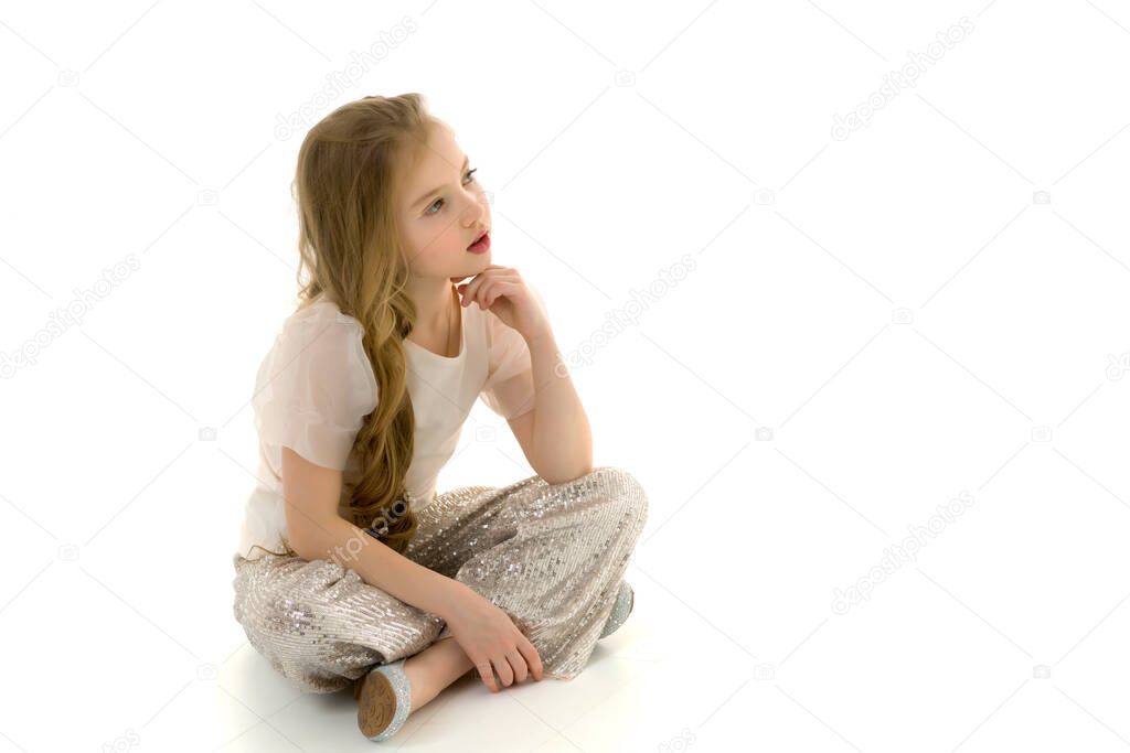 Little girl is sitting on the floor.The concept of a happy child