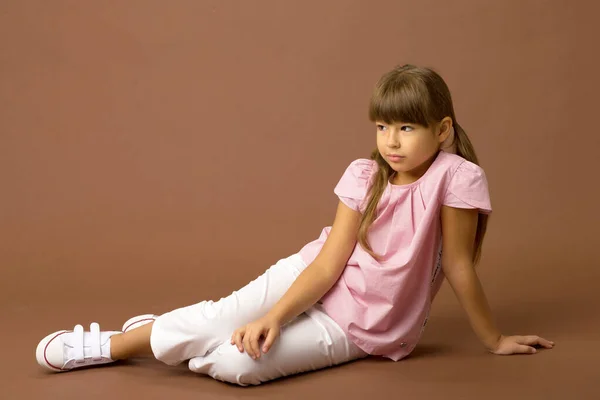 Ernstes kleines Mädchen sitzt auf dem Boden — Stockfoto