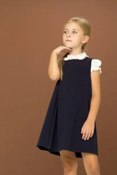 Aranyos szőke lány iskolai egyenruhában. — Stock Fotó