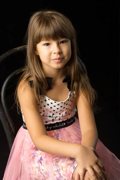 Adorable long haired girl sitting on chair — 图库照片