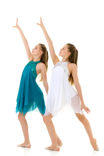 Two Twin Sisters in White and Blue Sport Dresses Dancing Togethe — Stockfoto