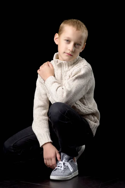 Portrait of cute teenage boy squatting — Stock Photo, Image