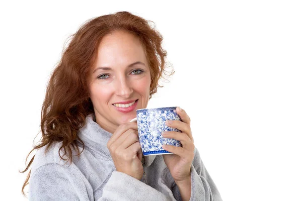 Smiling woman holding porcelain mug — Stock Photo, Image