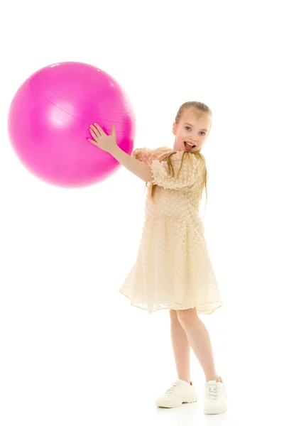 Little girl plays with a big ball for fitness — Stock Photo, Image