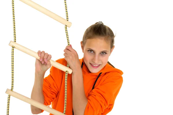 Sportive teen girl playing on rope ladder — Stock Photo, Image