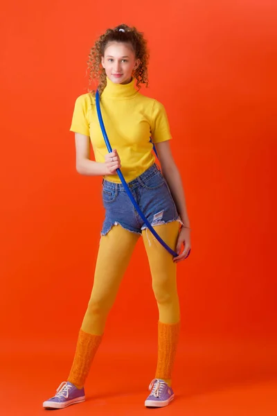 Sporty slim young girl exercising with hula hoop — Stock Photo, Image