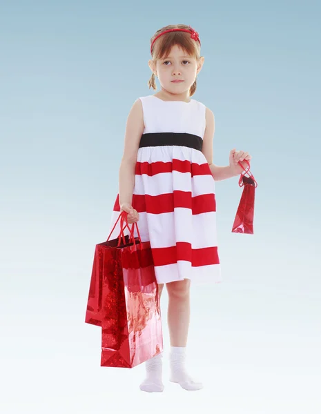 Serious girl holding gift bags. — Stock Photo, Image
