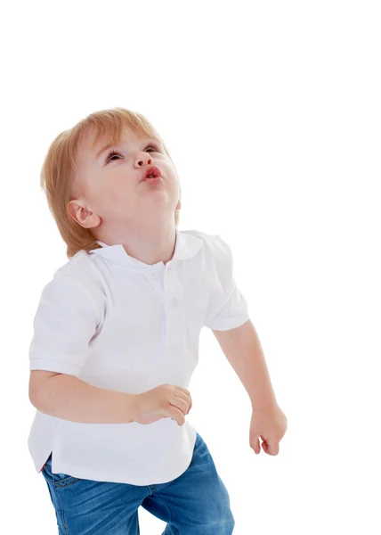 Маленький мальчик в белой рубашке смотрит вверх — стоковое фото