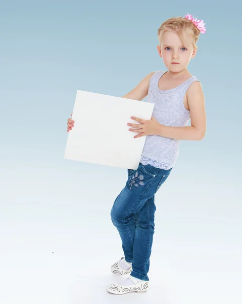 Menina segurando uma folha branca de papel . — Fotografia de Stock