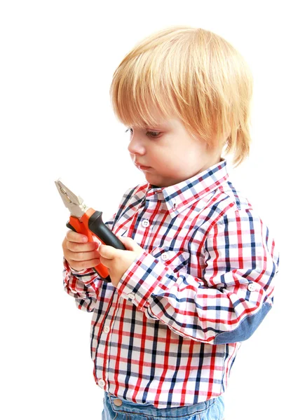 Little boy examines pliers. — Stock Photo, Image