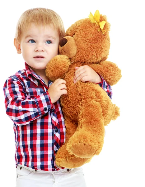 Little boy is playing in the kindergarten with a teddy bear. — Stock Photo, Image