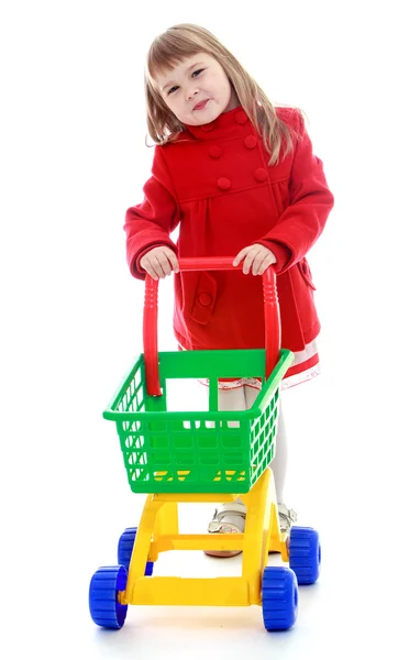 Niña muy de moda con un camión de juguete para los productos . —  Fotos de Stock