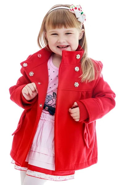 Fashionable little girl bright red coat in a beautiful pink dress. — Stock Photo, Image