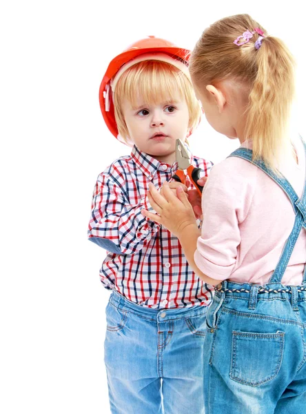 Girl and boy considers pliers. — Stock Photo, Image