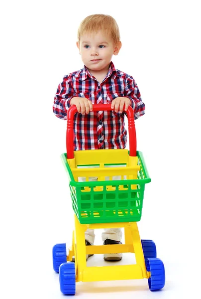 Very little boy rolls a toy truck. — Stock Photo, Image