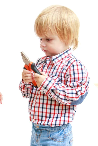 Little boy examines pliers. — Stock Photo, Image