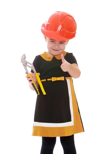 Niña positiva en el casco de construcción sosteniendo alicates . —  Fotos de Stock