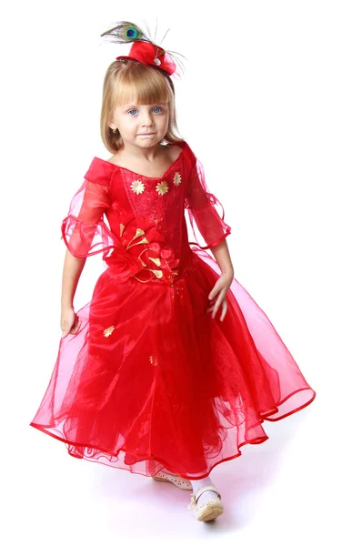 Adorable little princess in a long bright red dress. — Stock Photo, Image