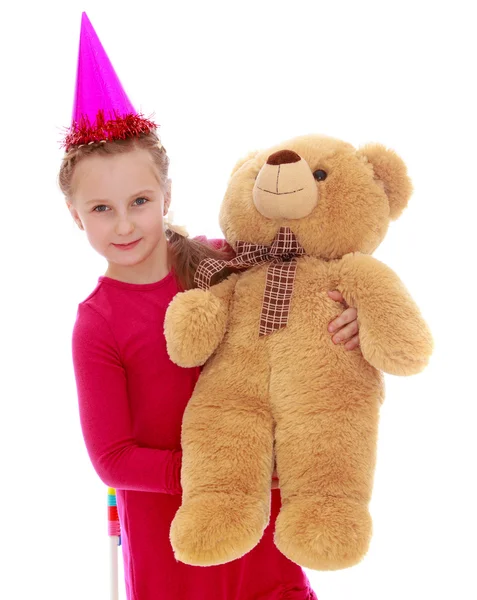 Girl in Winter Hat holding a teddy bear. — Stock Photo, Image