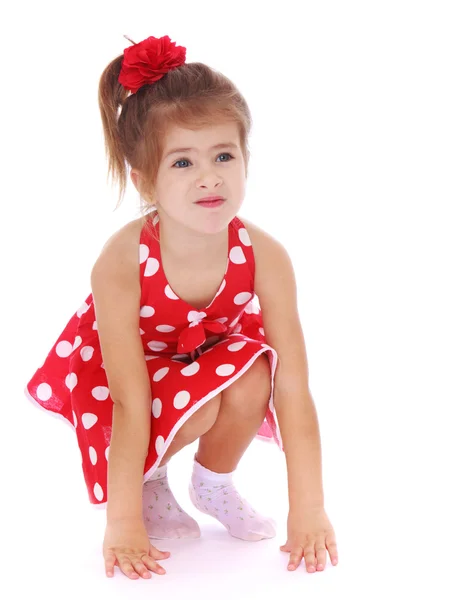 Adorable little girl squatted. — Stock Photo, Image