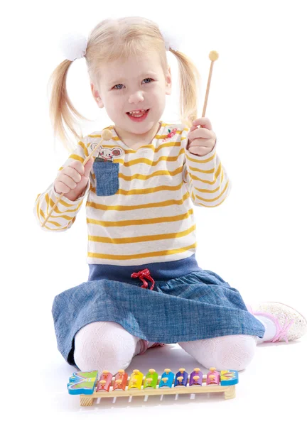 Beautiful little girl holding a hammer for xylophone. — Stock Photo, Image