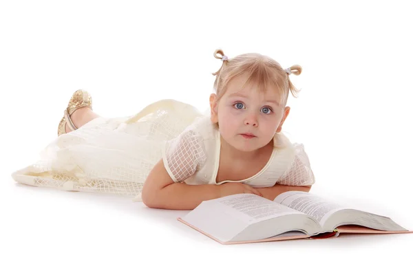 Roztomilá holčička ležela na podlaze a čtení knihy. — Stock fotografie