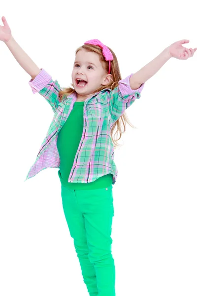 Happy little girl jumping hands wide apart. — Stock Photo, Image