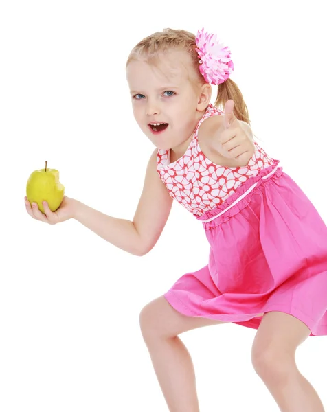 Funny little girl with an apple in his hand shows that everythin — Stock Photo, Image