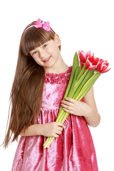 Fashionable little girl with long hair holding a bouquet of flow — Stock Photo, Image